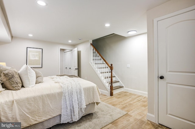 bedroom with baseboards, light wood-style flooring, and recessed lighting