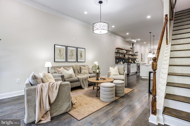 living area featuring dark wood-style flooring, crown molding, recessed lighting, baseboards, and stairs