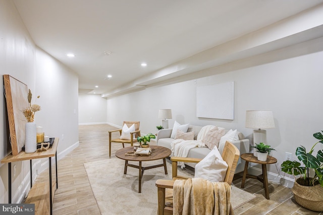 living area with recessed lighting, light wood-style flooring, and baseboards