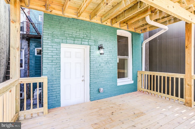 doorway to property featuring brick siding