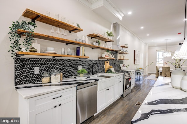 kitchen featuring white cabinets, range hood, stainless steel appliances, crown molding, and open shelves