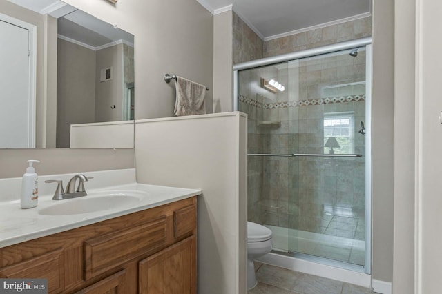 bathroom with vanity, toilet, a stall shower, and ornamental molding