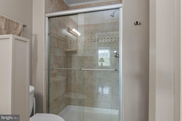 full bath featuring toilet and a shower stall