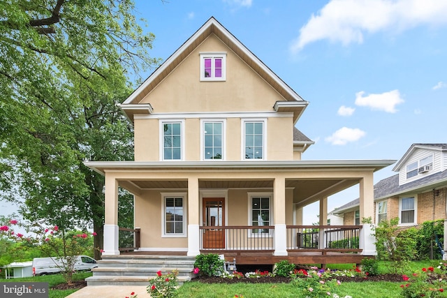 view of front facade with covered porch and stucco siding