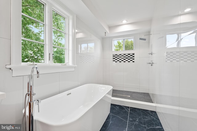 full bath featuring a healthy amount of sunlight, a stall shower, a freestanding bath, and recessed lighting