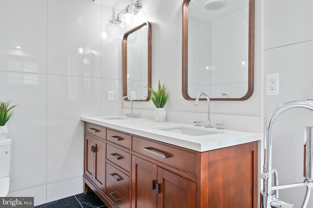 full bathroom featuring tile patterned floors, a sink, and double vanity