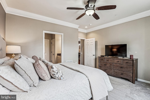 bedroom featuring baseboards, light carpet, connected bathroom, and crown molding