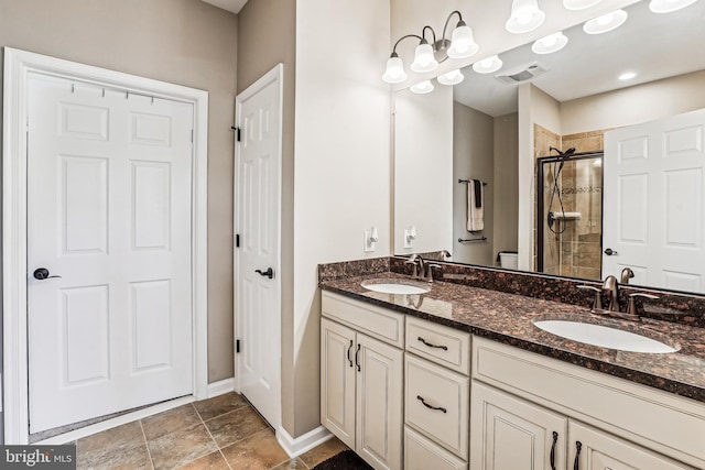 bathroom featuring a shower stall, double vanity, visible vents, and a sink