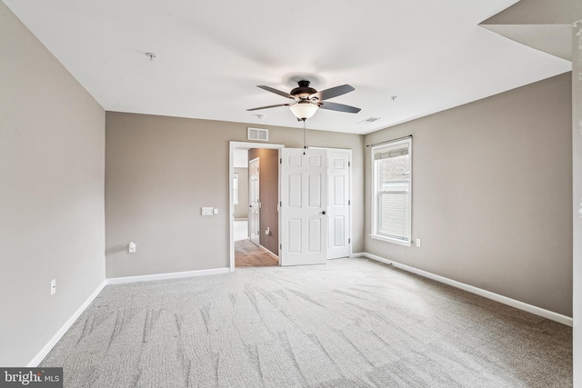 unfurnished bedroom featuring a closet, baseboards, visible vents, and carpet floors