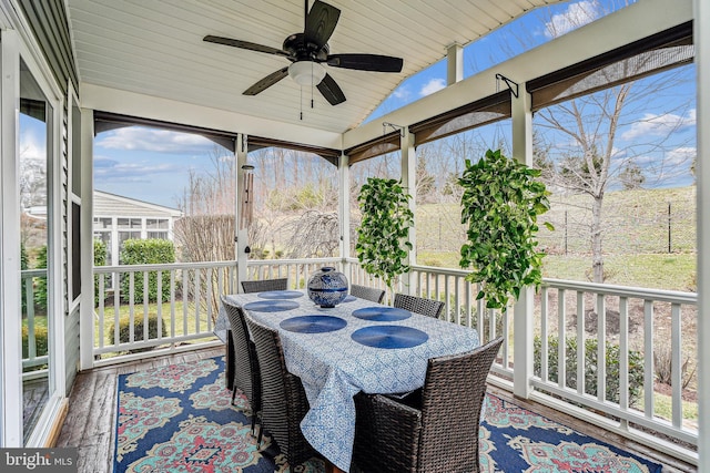 sunroom / solarium featuring vaulted ceiling, wooden ceiling, and ceiling fan