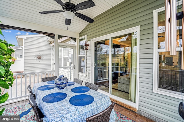 sunroom / solarium featuring a ceiling fan and vaulted ceiling