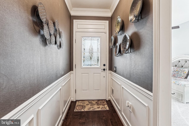 doorway to outside featuring dark wood finished floors, ornamental molding, wainscoting, and a decorative wall