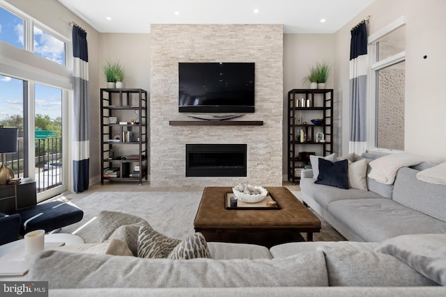 living area with recessed lighting and a fireplace