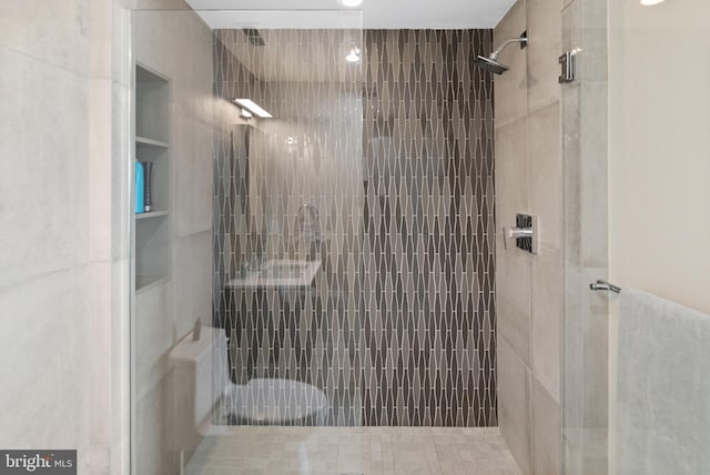 full bath with a tile shower