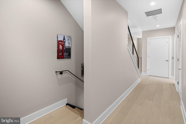 hall featuring stairway, baseboards, visible vents, light wood-style flooring, and recessed lighting