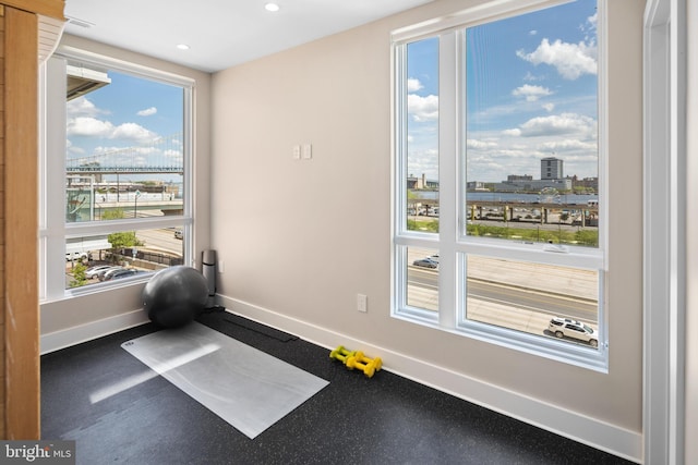 doorway to outside with a view of city, recessed lighting, and baseboards