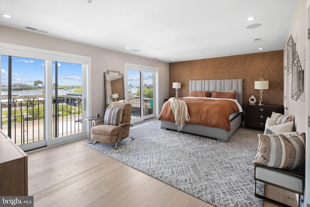 bedroom featuring visible vents, recessed lighting, wood finished floors, and access to outside