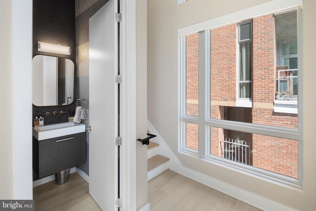 bathroom with vanity, baseboards, and wood finished floors