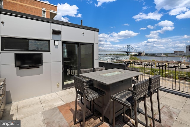 view of patio / terrace featuring a fire pit and a water view