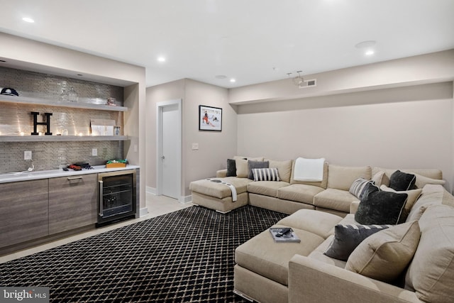 carpeted living room with a bar, wine cooler, recessed lighting, and visible vents