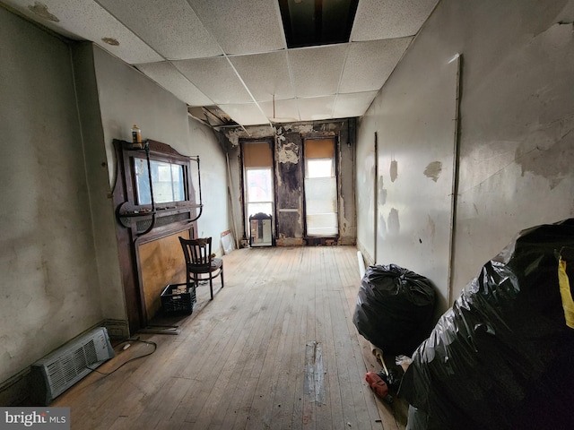 interior space with visible vents, hardwood / wood-style floors, and a drop ceiling