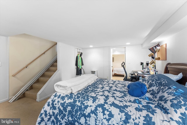 carpeted bedroom featuring a walk in closet and recessed lighting