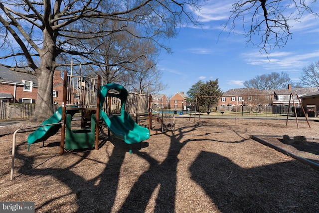 community play area with a residential view and fence