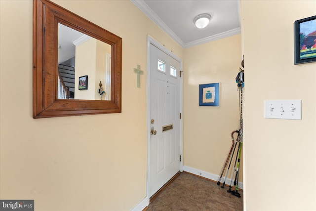 entrance foyer featuring ornamental molding and baseboards