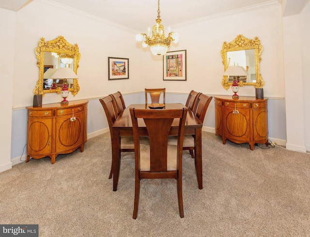 dining area featuring baseboards, carpet, an inviting chandelier, and crown molding