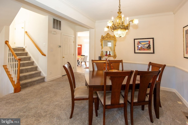 carpeted dining space featuring baseboards, visible vents, an inviting chandelier, stairs, and crown molding