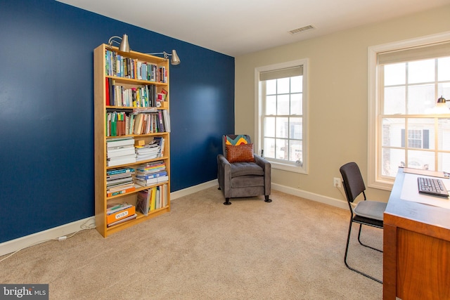 carpeted office featuring visible vents and baseboards