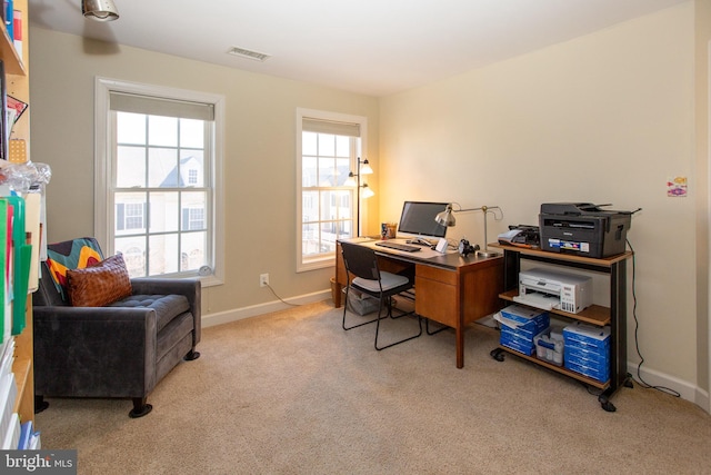 carpeted office with visible vents and baseboards