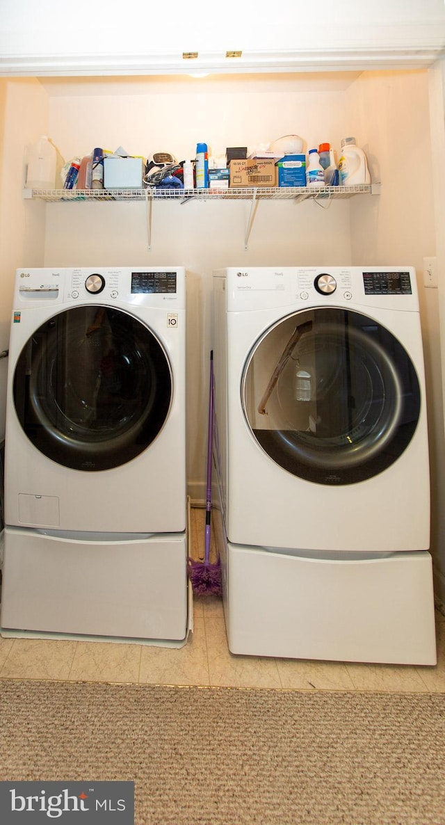 laundry room with tile patterned flooring, laundry area, and washer and dryer