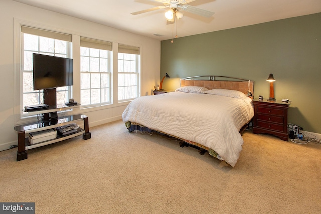 bedroom featuring baseboards, a ceiling fan, and carpet flooring