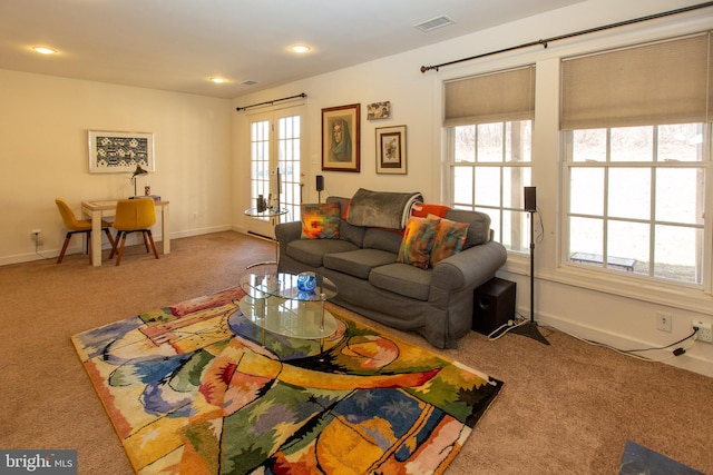 carpeted living room with recessed lighting, baseboards, visible vents, and french doors