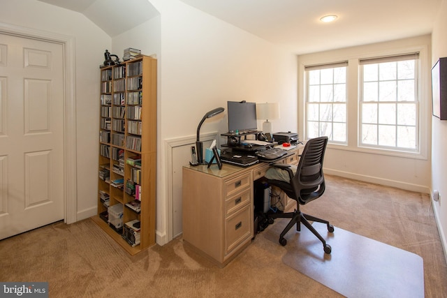 office featuring baseboards and light carpet