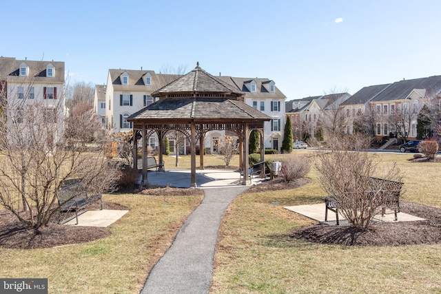 view of property's community with a gazebo, a residential view, and a lawn