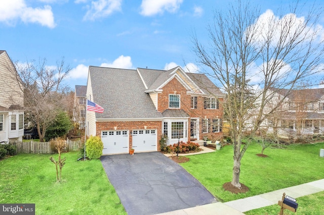 view of front of property with driveway, a shingled roof, fence, a front lawn, and brick siding