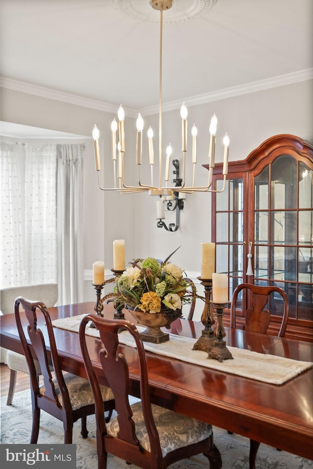 dining area with crown molding and wood finished floors