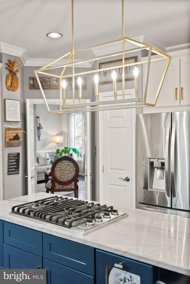 kitchen with blue cabinets, light stone countertops, appliances with stainless steel finishes, and ornamental molding