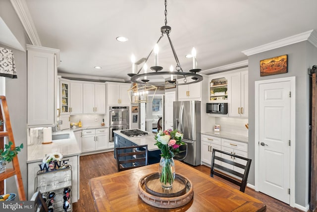 kitchen featuring ornamental molding, appliances with stainless steel finishes, white cabinetry, and decorative backsplash