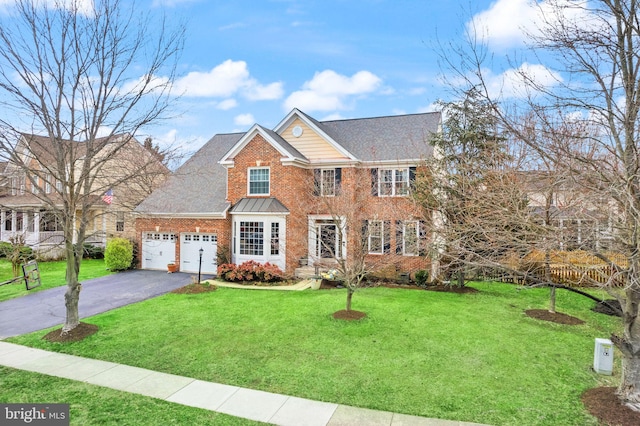 view of front of property featuring a garage, brick siding, driveway, and a front lawn