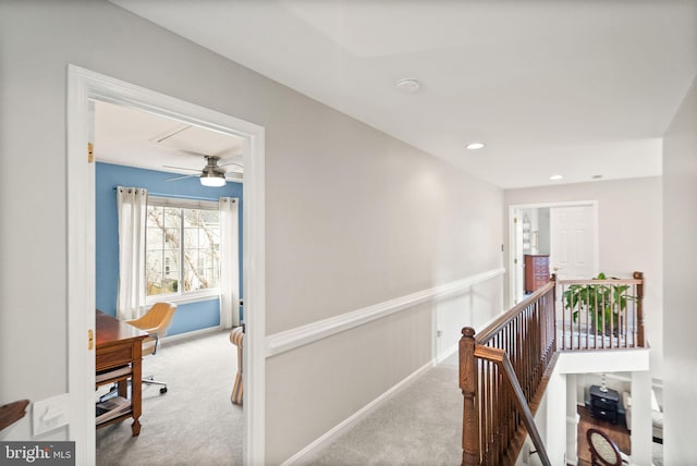 hallway featuring a wainscoted wall, carpet, an upstairs landing, and recessed lighting