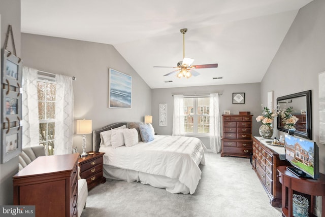 bedroom with light carpet, ceiling fan, vaulted ceiling, and visible vents