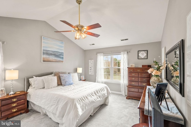 bedroom featuring light carpet, vaulted ceiling, visible vents, and a ceiling fan