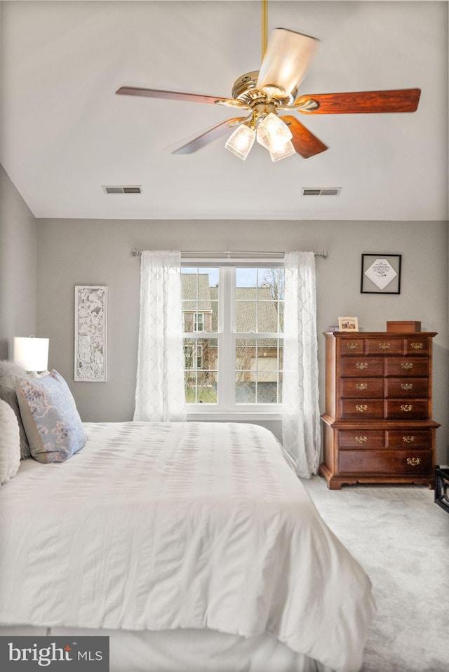 bedroom with a ceiling fan, visible vents, and carpet flooring