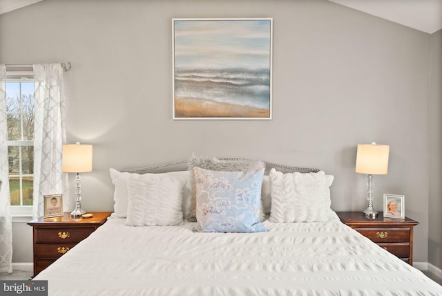 bedroom featuring carpet floors, lofted ceiling, and baseboards