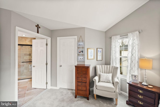 living area featuring lofted ceiling, baseboards, and carpet floors