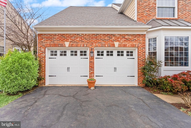 garage featuring aphalt driveway