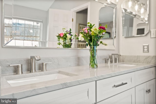 bathroom with a sink and double vanity